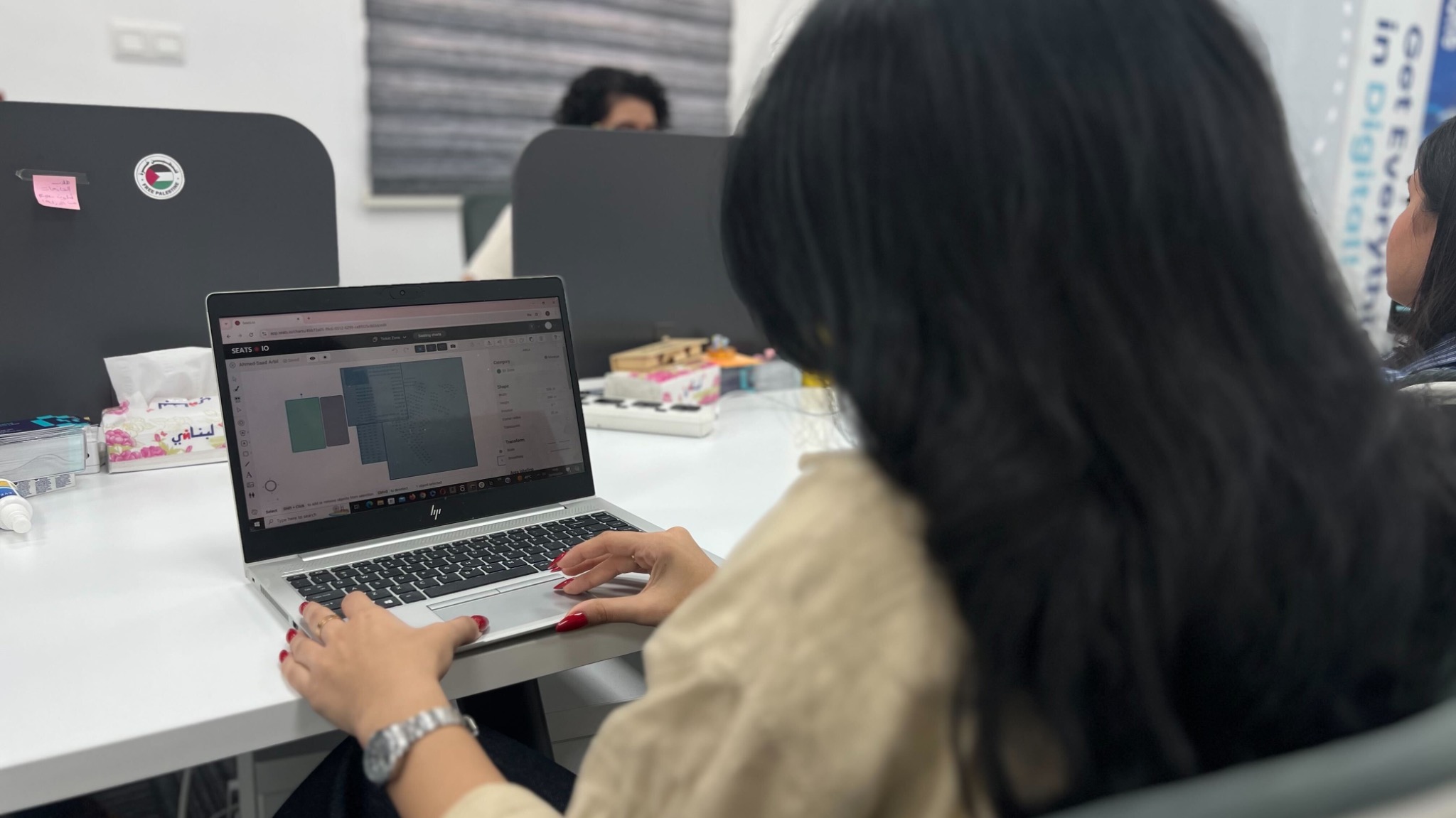 Digital Zone team member working on an event seating plan in the Baghdad office